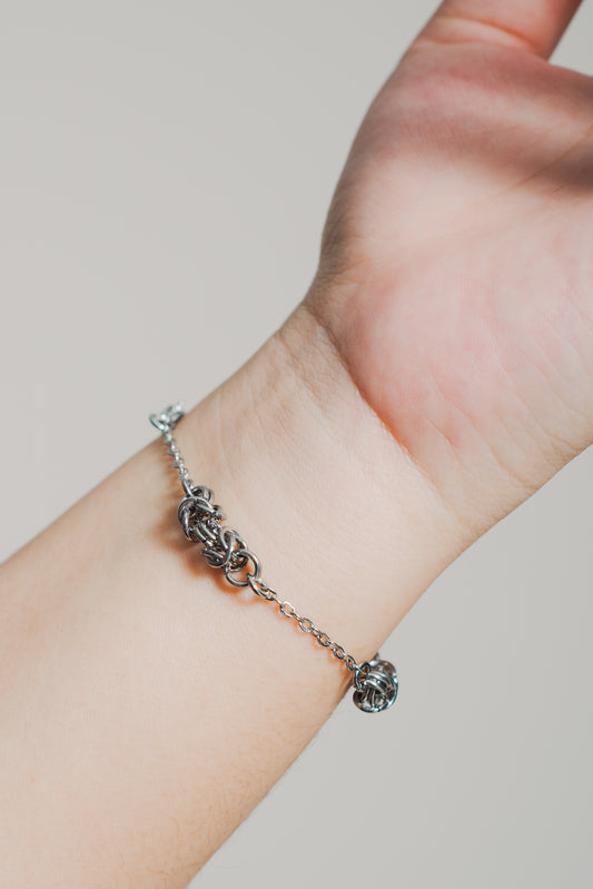silver toned bracelet on model's wrist